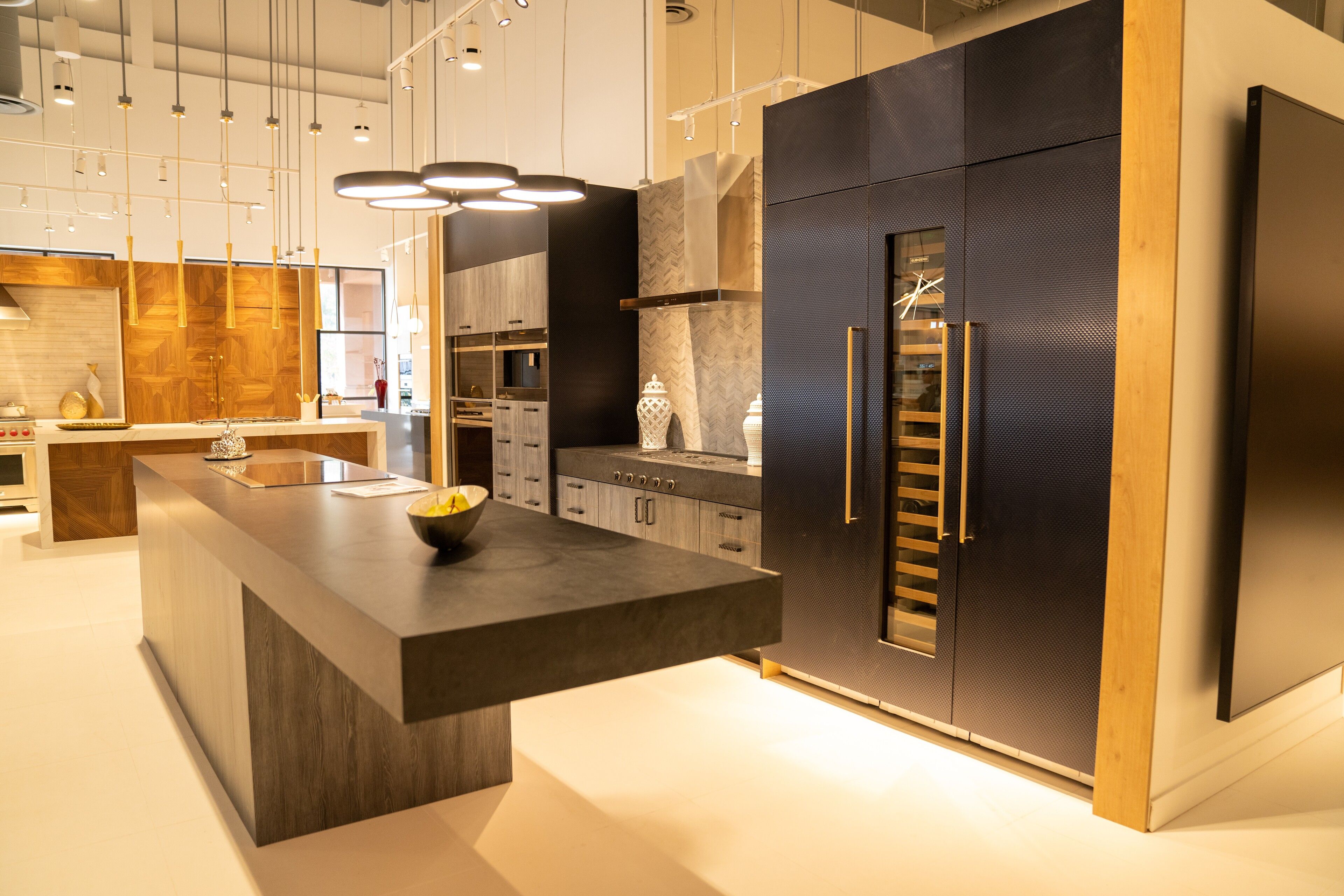 A dark slab kitchen with a cantilevered stone island