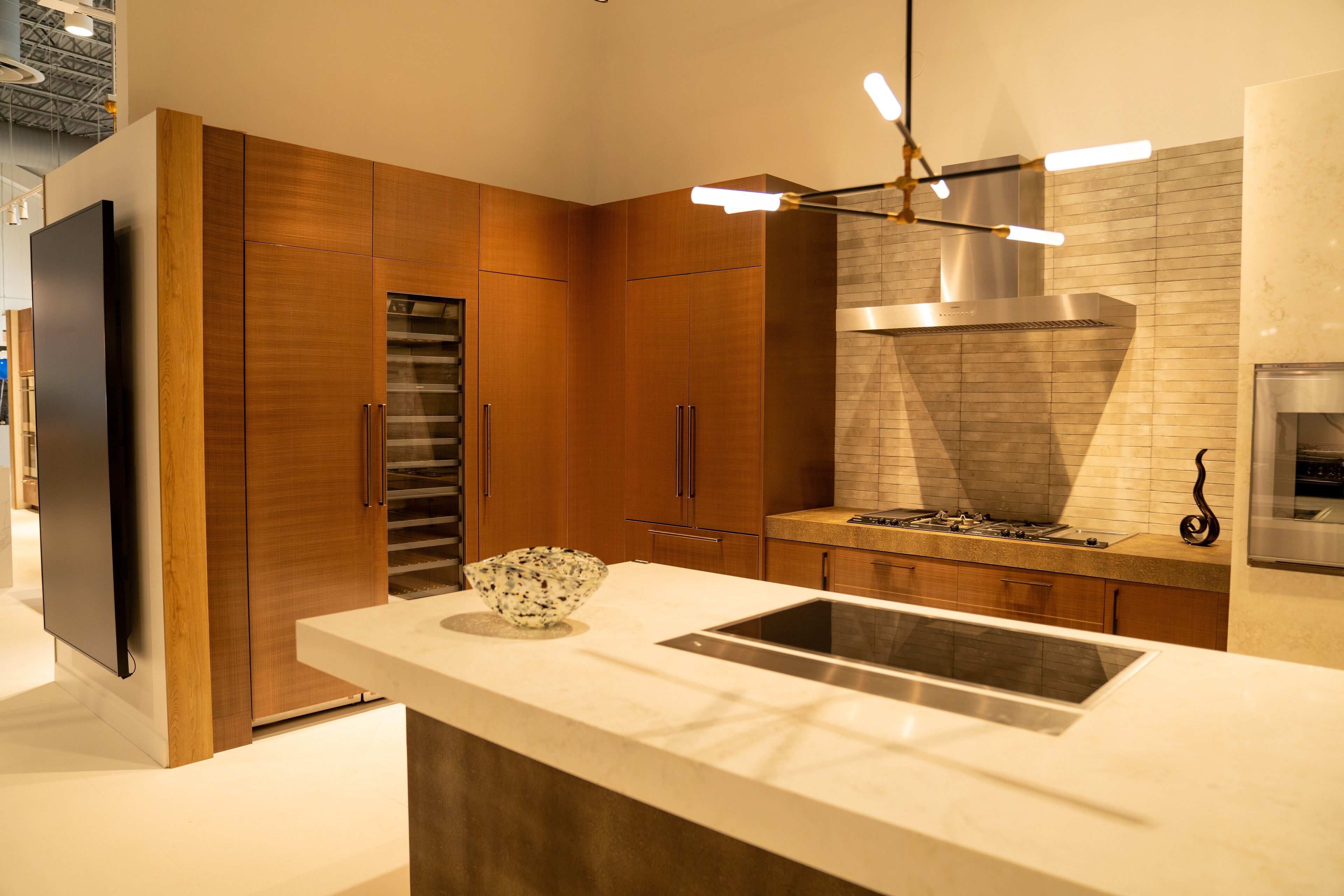 Warm walnut cabinetry with a white marble waterfall island