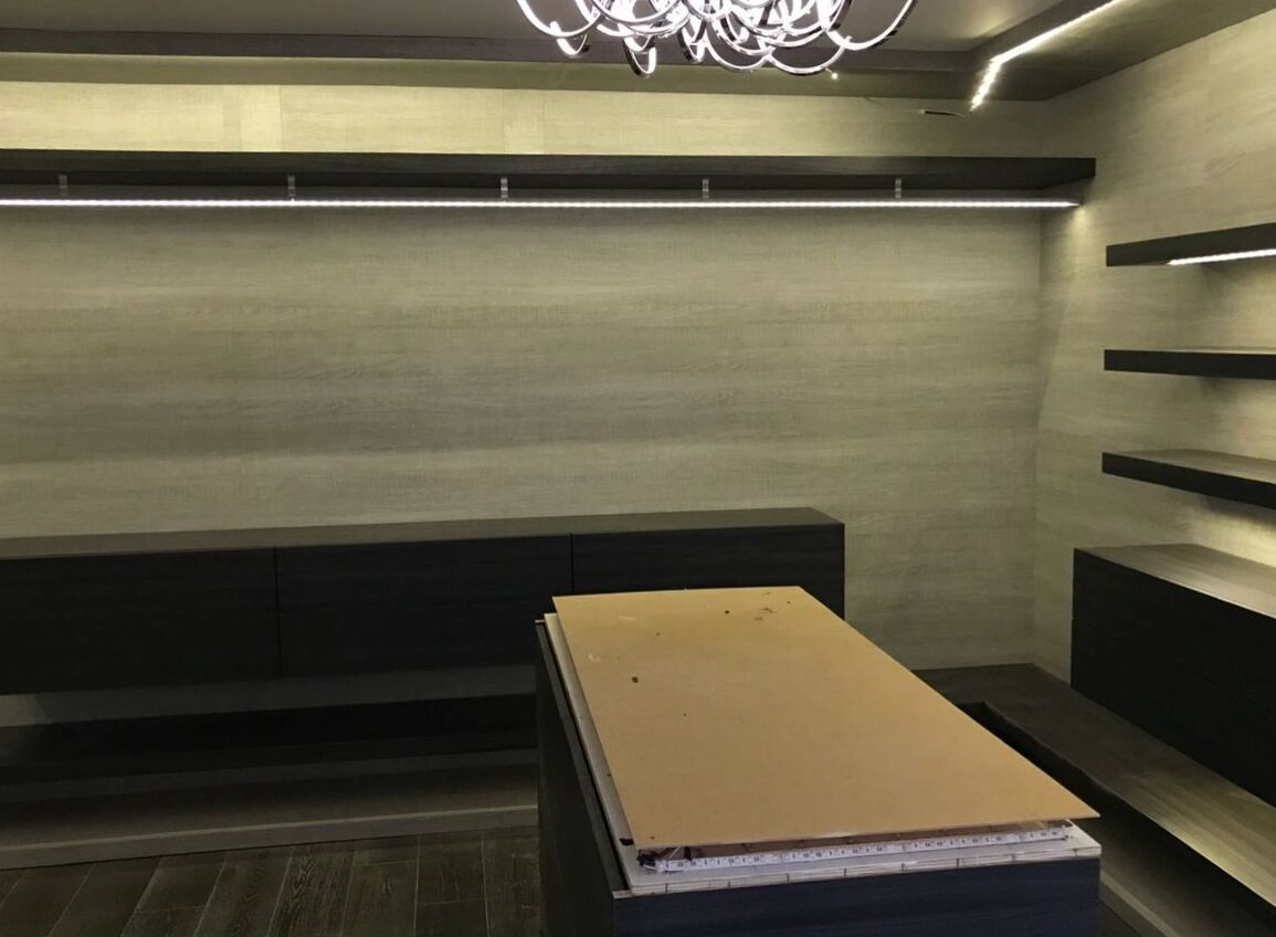 Bar area with dark wood backlit shelving