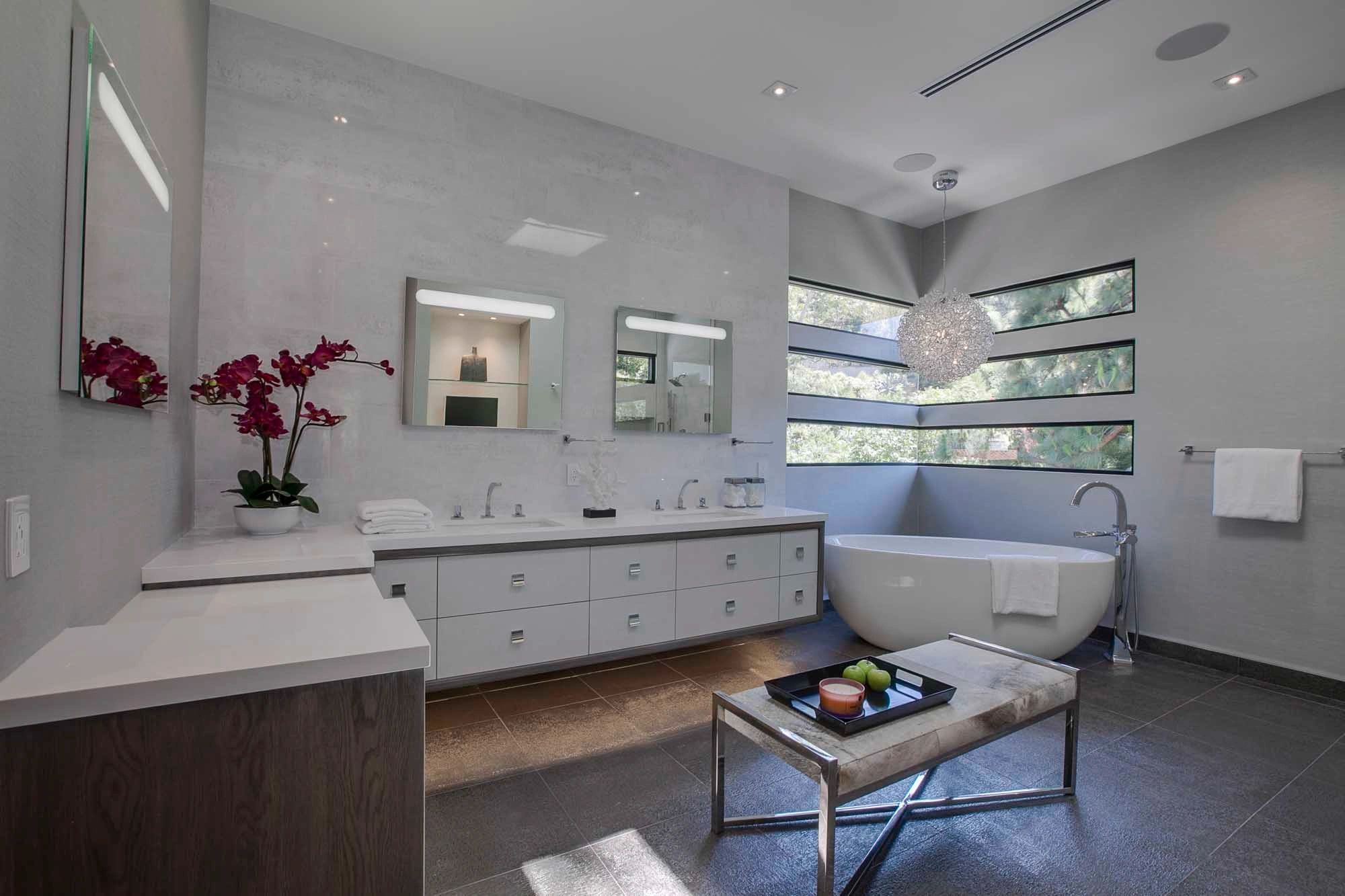Double sink vanity, light grey wood grain slab drawer fronts - custom cabinetry by NIC Cabinetry