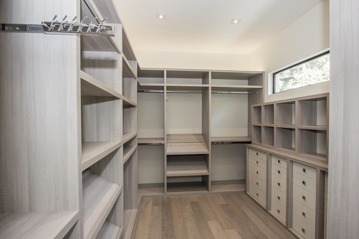 Walk-in closet cabinets, textured light grey wood panels