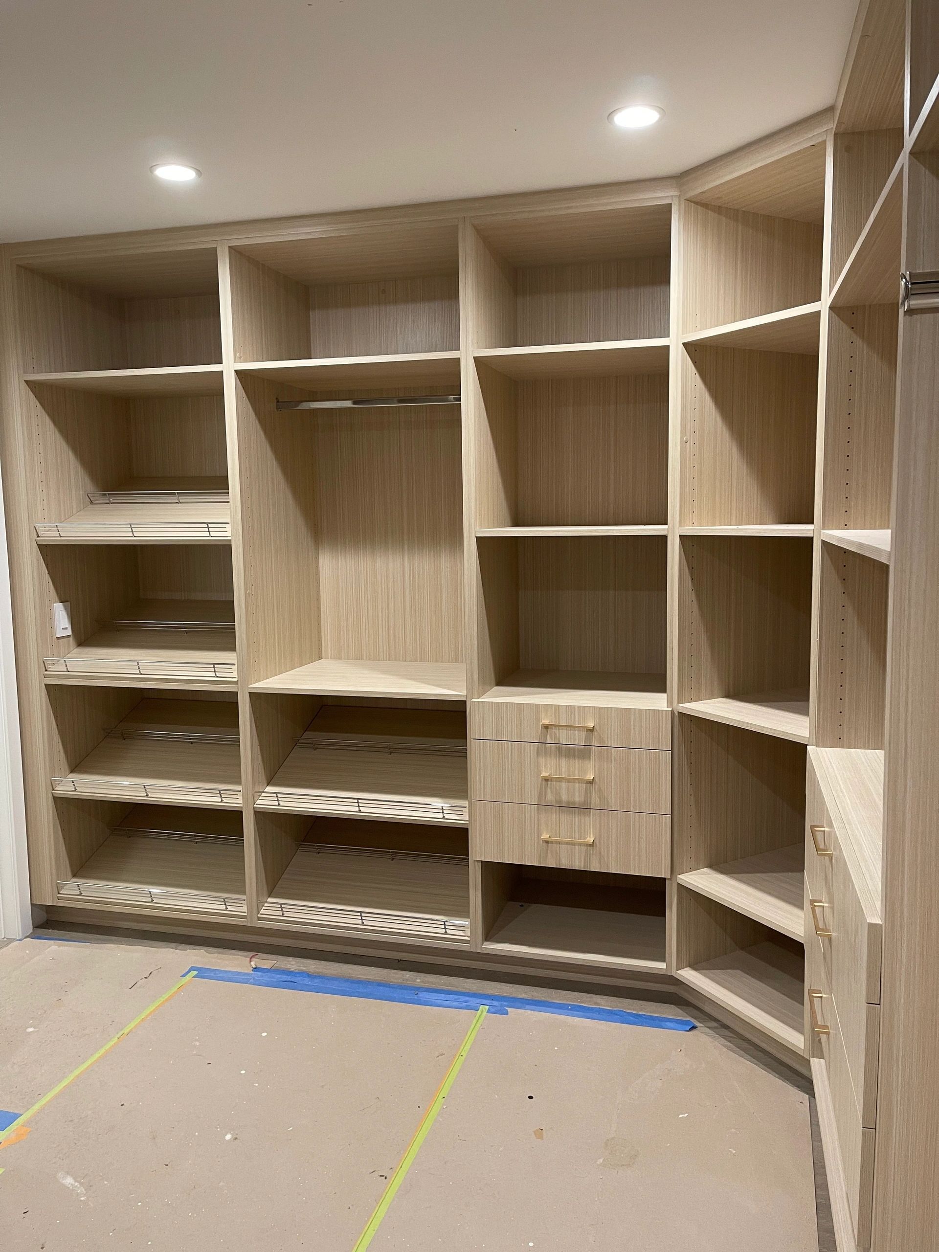 Walk-in closet shelving layout in white oak