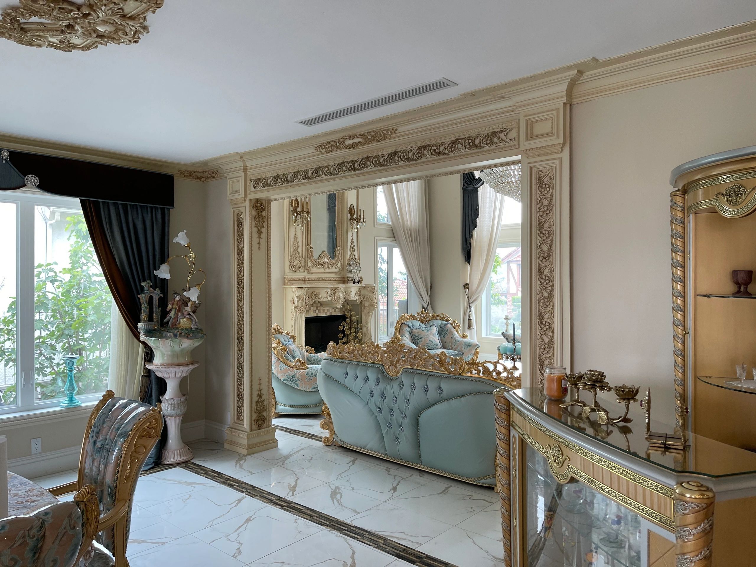 Traditional fireplace surround with ornate moldings and mirror paneling