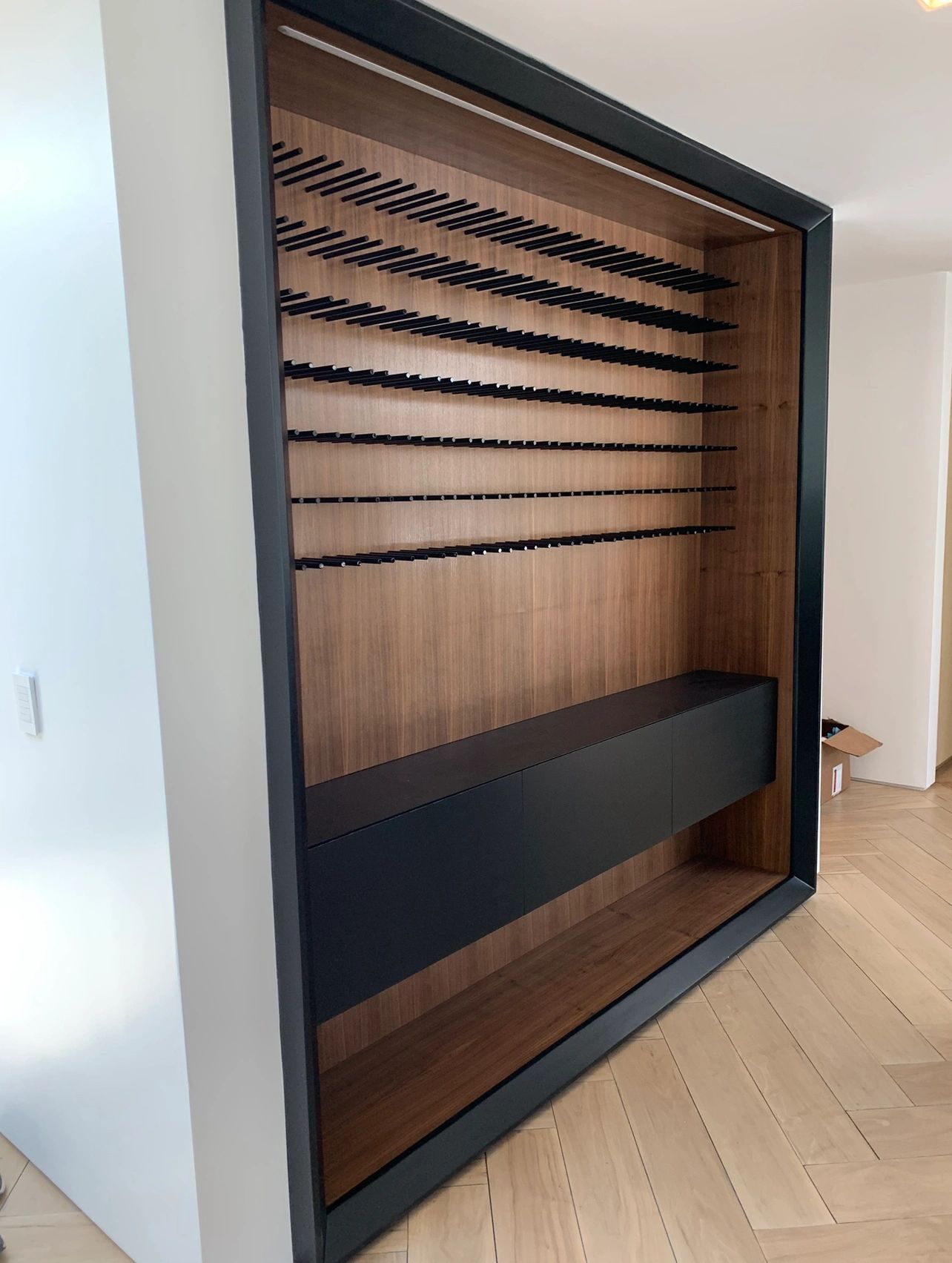 Modern wine room storage racking in a black wall frame